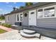 Inviting home entrance features updated steps, gray siding, and a secure front door at 1510 W Powhatan Ave, Tampa, FL 33603