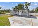 Cozy home with freshly painted gray siding and a well-manicured lawn for serene living at 1510 W Powhatan Ave, Tampa, FL 33603