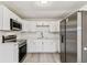 Bright kitchen featuring stainless steel appliances, subway tile backsplash, and modern white cabinetry at 1510 W Powhatan Ave, Tampa, FL 33603
