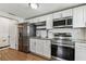 Updated kitchen featuring white cabinets and stainless steel appliances at 1510 W Powhatan Ave, Tampa, FL 33603