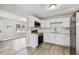 New kitchen with white cabinets, stainless steel appliances, and modern gray flooring at 1510 W Powhatan Ave, Tampa, FL 33603
