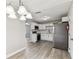 The kitchen features stainless steel appliances, white cabinets and modern lighting at 1510 W Powhatan Ave, Tampa, FL 33603