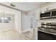 Bright kitchen features stainless steel appliances, white cabinetry and eat in dining area with great natural light at 1510 W Powhatan Ave, Tampa, FL 33603
