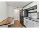 Bright updated kitchen with white cabinetry, granite counters, and wood-look floors at 1510 W Powhatan Ave, Tampa, FL 33603