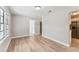 Open living room with modern floors leading to the kitchen with stainless steel appliances at 1510 W Powhatan Ave, Tampa, FL 33603
