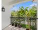 Charming tiled balcony offering views of the lush surroundings with a small decorative plant collection at 1731 W Watrous Ave # 202, Tampa, FL 33606