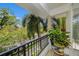 Charming balcony with wrought iron railings and potted plants with a view of the tree lined neighborhood at 1731 W Watrous Ave # 202, Tampa, FL 33606