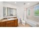 Bathroom featuring natural light, a large mirror, granite countertops, and a shower/tub combo at 1731 W Watrous Ave # 202, Tampa, FL 33606