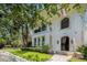 Charming two-story home with arched doorway, balcony, manicured lawn, and lush landscaping creates curb appeal at 1731 W Watrous Ave # 202, Tampa, FL 33606