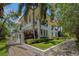 Elegant townhouse featuring a well-manicured lawn, lush tropical landscaping, and a private balcony at 1731 W Watrous Ave # 202, Tampa, FL 33606
