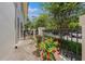 Charming patio area framed by a brick walkway, lush flowers and a black iron fence for added curb appeal at 1731 W Watrous Ave # 202, Tampa, FL 33606