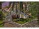 Elegant townhouse featuring a well-manicured lawn, lush tropical landscaping, and a private balcony at 1731 W Watrous Ave # 202, Tampa, FL 33606