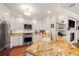 Updated kitchen with stainless steel appliances, granite countertops, white cabinetry, and hardwood floors at 1731 W Watrous Ave # 202, Tampa, FL 33606