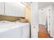 Well-lit laundry room with white cabinets and modern washer and dryer units for convenience at 1731 W Watrous Ave # 202, Tampa, FL 33606