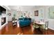 Bright living room with hardwood floors, fireplace, plantation shutters, stylish furnishings, and chandelier at 1731 W Watrous Ave # 202, Tampa, FL 33606