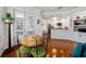 Open living space with hardwood floors features a wooden table and doorway leading into the kitchen at 1731 W Watrous Ave # 202, Tampa, FL 33606