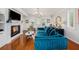 Bright living room with hardwood floors, fireplace, plantation shutters, stylish furnishings, and chandelier at 1731 W Watrous Ave # 202, Tampa, FL 33606