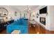 Bright living room with hardwood floors, fireplace, plantation shutters, stylish furnishings, and chandelier at 1731 W Watrous Ave # 202, Tampa, FL 33606
