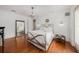 Light and airy main bedroom with chandelier, hardwood floors, and elegant décor at 1731 W Watrous Ave # 202, Tampa, FL 33606