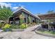 Stylish restaurant exterior featuring outdoor seating, lush plants, and modern architecture and design at 1731 W Watrous Ave # 202, Tampa, FL 33606