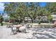 Inviting town square with outdoor seating, shaded by mature trees, with a beautiful water fountain as a focal point at 1731 W Watrous Ave # 202, Tampa, FL 33606