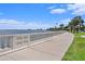 Picturesque waterfront view with a curved walkway, a decorative seawall, and city skyline in the distance at 1731 W Watrous Ave # 202, Tampa, FL 33606
