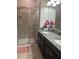 Bathroom with dual sinks, granite countertop, and a glass-enclosed shower at 17361 Old Tobacco Rd, Lutz, FL 33558
