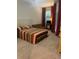 Comfortable bedroom with a tufted headboard, a futon, and bright red curtains at 17361 Old Tobacco Rd, Lutz, FL 33558