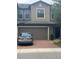 Two story townhome featuring an attached garage and brick paved driveway at 17361 Old Tobacco Rd, Lutz, FL 33558