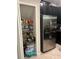 Walk in pantry with shelving next to stainless steel refrigerator at 17361 Old Tobacco Rd, Lutz, FL 33558