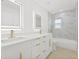Modern bathroom featuring double vanity, decorative mirrors, and tiled shower at 1901 76Th N Ave, St Petersburg, FL 33702