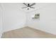 Well-lit bedroom features a ceiling fan, single window, and light wood-look flooring at 1901 76Th N Ave, St Petersburg, FL 33702