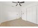 Clean bedroom with ceiling fan, double closets, light-colored floors, and white trim at 1901 76Th N Ave, St Petersburg, FL 33702