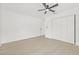 Spacious bedroom with ceiling fan, closet, light-colored floors, and white trim at 1901 76Th N Ave, St Petersburg, FL 33702