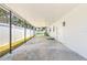 An open-air covered carport with a concrete floor, white siding, and a view of the backyard at 1901 76Th N Ave, St Petersburg, FL 33702