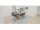 Contemporary dining room showcasing a wood table, modern chairs, and sun-filled windows at 1901 76Th N Ave, St Petersburg, FL 33702