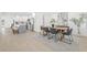 Open concept dining room with sleek table set, and new stainless steel kitchen appliances in background at 1901 76Th N Ave, St Petersburg, FL 33702