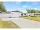 Exterior view of a single-story home featuring a well-manicured lawn and a two-car garage at 1901 76Th N Ave, St Petersburg, FL 33702