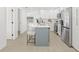 Open-concept kitchen with a gray island, quartz countertops, stainless steel appliances, and modern finishes at 1901 76Th N Ave, St Petersburg, FL 33702