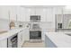 Modern kitchen featuring white cabinets, stainless steel appliances, and sleek countertops at 1901 76Th N Ave, St Petersburg, FL 33702