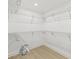 Bright walk-in closet featuring white walls, wire shelving, and wood-look flooring at 1901 76Th N Ave, St Petersburg, FL 33702