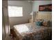 Cozy bedroom with a comfy queen bed, bedside table, and a window bringing in natural light at 19417 Gulf Blvd # B110, Indian Rocks Beach, FL 33785