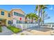 Charming waterfront condo with a white picket fence and lush tropical landscaping at 19417 Gulf Blvd # B110, Indian Rocks Beach, FL 33785