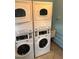 Community laundry room with two stacked washer and dryer units available at 19417 Gulf Blvd # B110, Indian Rocks Beach, FL 33785