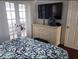 Bright main bedroom with furniture and large tv, perfect for relaxing after a long day at 19417 Gulf Blvd # B110, Indian Rocks Beach, FL 33785