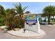 Barefoot Beach Resort sign surrounded by lush landscaping with vibrant greenery in a prime location at 19417 Gulf Blvd # B110, Indian Rocks Beach, FL 33785