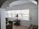 Bright sunroom with tiled flooring, large windows, and comfortable seating is the perfect relaxation spot at 19417 Gulf Blvd # B110, Indian Rocks Beach, FL 33785