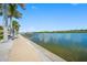 Scenic waterfront view with a walkway along the canal and docks for boating at 19417 Gulf Blvd # B110, Indian Rocks Beach, FL 33785