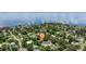 Scenic aerial view of waterfront community with mature trees and charming homes with pools at 211 60Th S Ave, St Petersburg, FL 33705