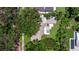 Aerial view of the home showcasing its backyard pool and landscaping, surrounded by mature trees at 211 60Th S Ave, St Petersburg, FL 33705